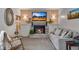 Cozy living room featuring a brick fireplace and comfortable seating at 8427 Chase Dr, Arvada, CO 80003