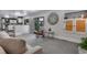 Open concept living room with kitchen access and sliding door to back yard at 8427 Chase Dr, Arvada, CO 80003