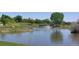 Community pond featuring a water fountain and lush green surroundings at 8427 Chase Dr, Arvada, CO 80003