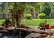 Landscaped backyard pond with rock accents, lush greenery, and decorative features at 8427 Chase Dr, Arvada, CO 80003