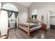 Bedroom with wood floors, a four-poster bed, and an arched window at 11105 E Alameda Ave # 204, Aurora, CO 80012
