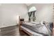 Bedroom with a four-poster bed and an arched window overlooking a green space at 11105 E Alameda Ave # 204, Aurora, CO 80012