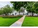 Landscaped grounds feature a walking path and lush green lawn near community housing at 11105 E Alameda Ave # 204, Aurora, CO 80012