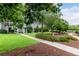 Exterior community view with mature trees, manicured lawns, and walkways for enjoyable outdoor living at 11105 E Alameda Ave # 204, Aurora, CO 80012