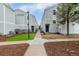 Exterior of townhomes with a sidewalk leading to the front door and well-manicured lawns at 11105 E Alameda Ave # 204, Aurora, CO 80012