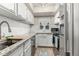 Bright kitchen featuring granite countertops, white cabinets, stainless steel appliances, and tile backsplash at 11105 E Alameda Ave # 204, Aurora, CO 80012
