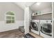 Spacious laundry room featuring modern washer and dryer units plus storage shelves at 11105 E Alameda Ave # 204, Aurora, CO 80012