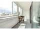 Sunlit porch with bright white paint, complemented by large windows and a plant stand at 11105 E Alameda Ave # 204, Aurora, CO 80012