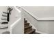 A staircase with wooden steps and white painted railing at 11105 E Alameda Ave # 204, Aurora, CO 80012
