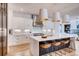 Bright kitchen with white cabinets, quartz countertops, and a large island with seating at 2435 S Josephine St, Denver, CO 80210
