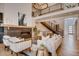 Open-concept living room with a fireplace, modern decor, and a staircase at 2435 S Josephine St, Denver, CO 80210