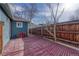 A cozy back patio features red pavers, a wooden fence, and a blue exterior wall at 2819 W 43Rd Ave, Denver, CO 80211