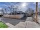A fenced backyard features a gravel area with a wooden fence and a blue house at 2819 W 43Rd Ave, Denver, CO 80211