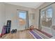 Bright bedroom with hardwood floors, large windows with drapes, and workout equipment at 2819 W 43Rd Ave, Denver, CO 80211