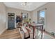 Bright dining room featuring wood floors, a wooden table with seating, and a classic blue door at 2819 W 43Rd Ave, Denver, CO 80211