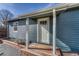 Inviting entrance with a wooden deck and blue siding, enhancing curb appeal at 2819 W 43Rd Ave, Denver, CO 80211