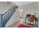 Hallway featuring stairs, a desk, and doorway to living room, offering a glimpse of an open, bright home at 2819 W 43Rd Ave, Denver, CO 80211