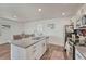 Well-lit kitchen features stainless steel appliances, a spacious island, and an adjacent dining area at 2819 W 43Rd Ave, Denver, CO 80211