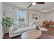 Cozy living room filled with natural light, neutral toned furniture, and warm wood floors at 2819 W 43Rd Ave, Denver, CO 80211