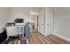 Bright office with a desk and chair set up, with wood flooring, and open doorway at 2819 W 43Rd Ave, Denver, CO 80211