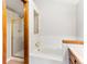This well-lit bathroom features a shower and a soaking tub with white tile surround at 11181 Main Range Trl, Littleton, CO 80127