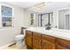 Bright bathroom featuring a large vanity, a large mirror, and a glass-enclosed shower at 11181 Main Range Trl, Littleton, CO 80127