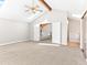 The primary bedroom features a ceiling fan, vaulted ceiling, and access to the upper loft and ensuite bathroom at 11181 Main Range Trl, Littleton, CO 80127