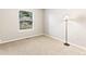 Cozy carpeted bedroom with natural light from the window and simple décor at 11181 Main Range Trl, Littleton, CO 80127