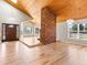 Open concept living room featuring hardwood floors, vaulted ceilings, and lots of natural light at 11181 Main Range Trl, Littleton, CO 80127
