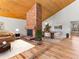 Inviting living area features hardwood floors, brick fireplace, and stylish furnishings at 11181 Main Range Trl, Littleton, CO 80127