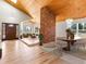 Bright open living area featuring hardwood floors, a brick fireplace and comfortable furniture at 11181 Main Range Trl, Littleton, CO 80127