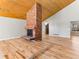 Spacious living room with vaulted wood ceilings and a brick fireplace at 11181 Main Range Trl, Littleton, CO 80127