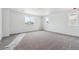 Spacious bedroom with neutral carpet and two windows providing ample natural light at 9257 Truckee Ct, Commerce City, CO 80022