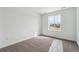 Bedroom with natural light from a large window and neutral carpet at 9257 Truckee Ct, Commerce City, CO 80022
