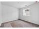 Bright bedroom features neutral carpet, a window, and fresh white walls at 9257 Truckee Ct, Commerce City, CO 80022