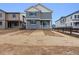 New construction two-story home with gray siding, a small porch, and fresh landscaping at 9257 Truckee Ct, Commerce City, CO 80022