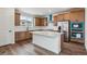Modern kitchen with stainless steel appliances, a center island, and wooden cabinets at 9257 Truckee Ct, Commerce City, CO 80022