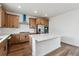 Well-lit kitchen with an island, stainless steel appliances, and wooden cabinets at 9257 Truckee Ct, Commerce City, CO 80022