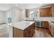 Bright kitchen with an island, stainless steel appliances, and hardwood floors at 9257 Truckee Ct, Commerce City, CO 80022