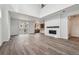 Spacious living room with sleek hardwood floors, a modern fireplace, and ample natural light at 9257 Truckee Ct, Commerce City, CO 80022