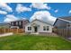 Well-maintained backyard featuring ample green space, fenced perimeter, and landscaping at 653 S Hoover Ave, Fort Lupton, CO 80621