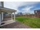 Large backyard featuring green grass, fenced perimeter, and patio area, perfect for relaxing at 653 S Hoover Ave, Fort Lupton, CO 80621