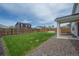 Backyard showcasing green grass, patio, fenced perimeter and landscaping at 653 S Hoover Ave, Fort Lupton, CO 80621