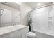 Clean bathroom featuring neutral tile backsplash, shower-tub combo, and modern fixtures at 653 S Hoover Ave, Fort Lupton, CO 80621