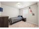 Comfortable bedroom featuring neutral colors, window, carpeting, and furnishings at 653 S Hoover Ave, Fort Lupton, CO 80621