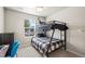 Cozy bedroom with modern bunkbeds, natural light, and plush carpeting at 653 S Hoover Ave, Fort Lupton, CO 80621