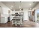 Bright kitchen featuring stainless steel appliances, island seating, and seamless access to the outdoors at 653 S Hoover Ave, Fort Lupton, CO 80621