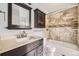 Modern bathroom featuring a tile shower and dark wood vanity at 2694 S Xanadu Way # D, Aurora, CO 80014