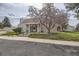 Charming home exterior with a blossoming tree and well-maintained lawn at 2694 S Xanadu Way # D, Aurora, CO 80014