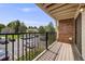 Spacious balcony overlooking the parking area and community greenery at 401 S Kalispell Way # 206, Aurora, CO 80017
